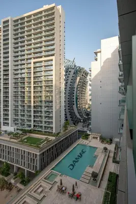 an overhead view of a pool in a city with tall buildings at DAMAC Majestine Studio with Pool, Spa and Gym Near Bus & DubaiMall in Dubai