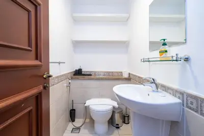 a bathroom with a white toilet and a sink at Elegant Palm Living Upgraded Golden Mile 1 Bed in Dubai