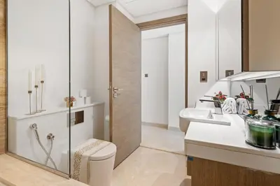 a bathroom with a toilet and a sink at Nice New Studio 2 Double Beds In Downtown, Free Parking in Dubai