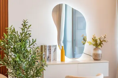 a mirror on a shelf in a room with plants at Nice New Studio 2 Double Beds In Downtown, Free Parking in Dubai
