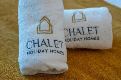 two towels with the words chalk holiday homes on them at Nice New Studio 2 Double Beds In Downtown, Free Parking in Dubai