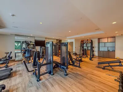 a gym with several treadmills and exercise bikes at Act tower 2BR, near burj khalifa in Dubai