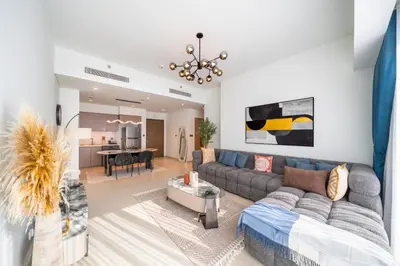 a living room with a couch and a table at Act tower 2BR, near burj khalifa in Dubai