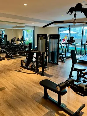 a gym with a bunch of treadmills and machines at Act tower 2BR, near burj khalifa in Dubai