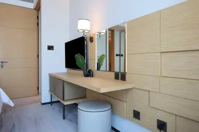 a room with a desk with a tv and a mirror at Scenic 1BR - The Address JBR in Dubai