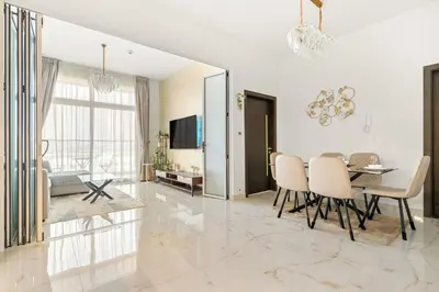 a dining room with a table and chairs in a room at FIRST CLASS 1BR Luxe Living in Jewelz in Dubai