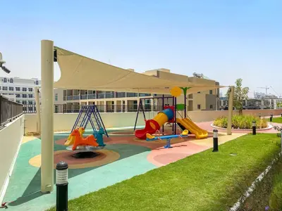 a playground with a slide and a swing at FIRST CLASS 1BR Luxe Living in Jewelz in Dubai