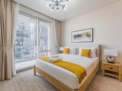 a bedroom with a large bed and a large window at 1BR at Vida -Steps from Dubai Mall & Burj Khalifa in Dubai