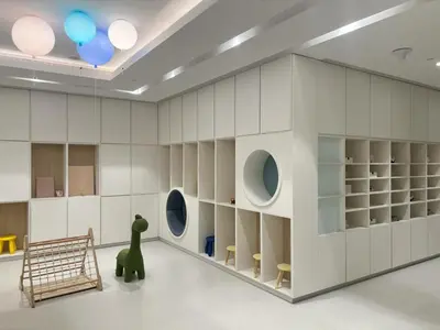 a room with white walls and a wall with circular windows at Skyline View - 2 Balconies - Pool plus Gym - Sleeps 8 in Dubai