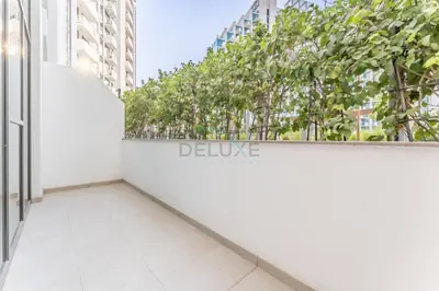 a balcony in a building with trees in the background at Modern Studio with Huge Balcony, Near Dubai Canal and Mins to Downtown Dubai, Fawad Azizi Residence, Al Jaddaf by Deluxe Holiday Homes in Dubai
