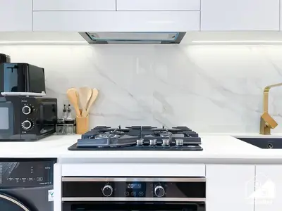 a stove top in a kitchen with a microwave at JVC Retreat with Pool & Balcony in Dubai