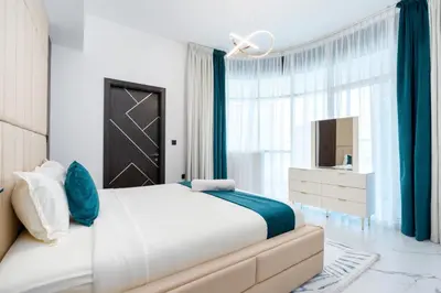 a bedroom with a large bed and a window at Ahlan HH - Exclusive 2-BR Apartment in Opalz by Danube - Balcony with Mini Pool in Dubai