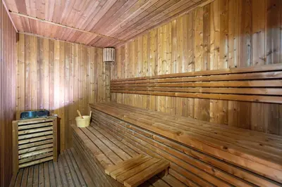 a wooden sauna with a wooden bench in it at Ahlan HH - Exclusive 2-BR Apartment in Opalz by Danube - Balcony with Mini Pool in Dubai