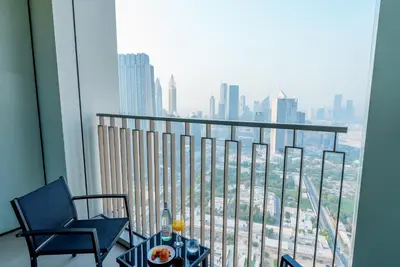 a balcony with a table and chairs and a view of a city at 54th Floor Burj Khalifa&Mall Access Infinity Pool in Dubai