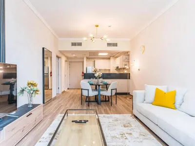 a living room with a couch and a table at Spacious 1BR-Walk to Dubai Mall & Khalifa-Downtown Dubai in Dubai