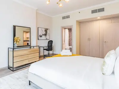 a bedroom with a large white bed and a mirror at Spacious 1BR-Walk to Dubai Mall & Khalifa-Downtown Dubai in Dubai