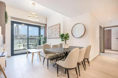 a dining room with a table and chairs and a mirror at Urban Family Home minutes from Downtown in Dubai