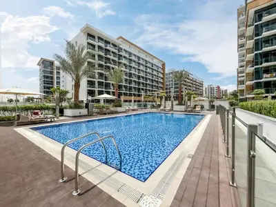 a swimming pool at a hotel with buildings in the background at Urban Family Home minutes from Downtown in Dubai