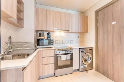 a kitchen with a sink and a stove at Steps from Dubai Hills Park, Walk to Dubai Hills Mall, 15-Minute Drive to Burj Khalifa and Dubai Mall, Sway Residences, Dubai Hills by Deluxe Holiday Homes in Dubai
