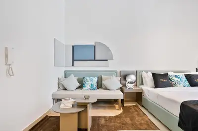 a living room with a bed and a couch at Posh Studio in MBR by Deleguest in Dubai