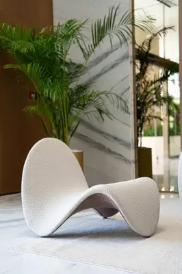 a white shoe sitting on the floor in a lobby at Lavish Studio Apt in Binghatti Azure - Pool & Gym in Dubai
