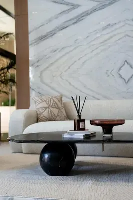 a living room with a couch and a coffee table at Lavish Studio Apt in Binghatti Azure - Pool & Gym in Dubai