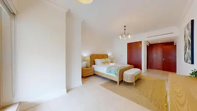 a bedroom with a bed and a table in a room at Al Mesk Tower - One Bed with Scenic Marina Views in Dubai