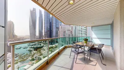 a balcony with a table and chairs and a view of a city at Al Mesk Tower - One Bed with Scenic Marina Views in Dubai