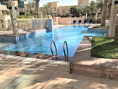 a swimming pool with blue water in a building at Al Mesk Tower - One Bed with Scenic Marina Views in Dubai