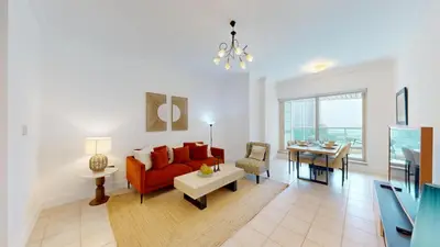 a living room with a red couch and a table at Al Mesk Tower - One Bed with Scenic Marina Views in Dubai