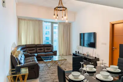 a living room with a couch and a table at Luxury 2 BHK in Ocean Heights at Dubai Marina Living with Stunning Views in Dubai