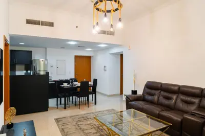 a living room with a couch and a table at Luxury 2 BHK in Ocean Heights at Dubai Marina Living with Stunning Views in Dubai