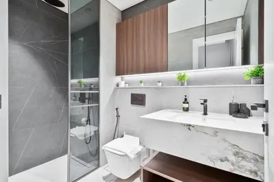 a bathroom with a sink and a toilet and a shower at 2BR Homely Apartment in Arjan in Dubai
