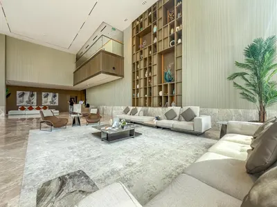 a living room with couches and a palm tree at 2BR Homely Apartment in Arjan in Dubai
