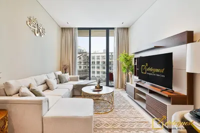 a living room with a couch and a tv at 2BR Homely Apartment in Arjan in Dubai