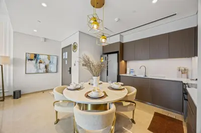 a kitchen and dining room with a table and chairs at Burj Khalifa and Dubai Fountian Direct View - Luxury 2BR Flat - Downtown Dubai in Dubai