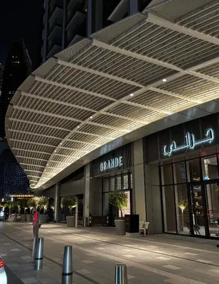 a large building with a canopy over a street at Burj Khalifa and Dubai Fountian Direct View - Luxury 2BR Flat - Downtown Dubai in Dubai