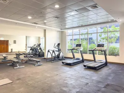 a gym with treadmills and ellipticals in a room at Dunya Tower 1BR Heart of Dubai Downtown in Dubai