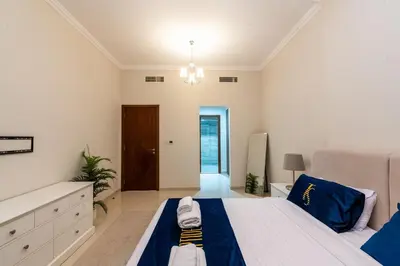 a large bedroom with a large bed and a chandelier at Dunya Tower 1BR Heart of Dubai Downtown in Dubai