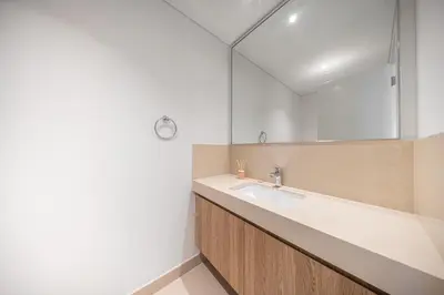 a bathroom with a sink and a mirror at Burj View Chic 2BR Downtown Dubai in Dubai