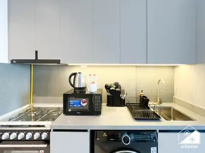a kitchen counter with a coffee maker and a microwave at Stylish Studio Living l MAG Meydan in Dubai