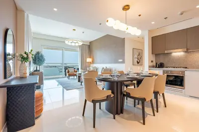a kitchen and dining room with a table and chairs at Luxe 2 bedroom Apartment full Sea and Palm Views in Dubai