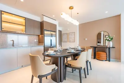 a kitchen and dining room with a table and chairs at Luxe 2 bedroom Apartment full Sea and Palm Views in Dubai