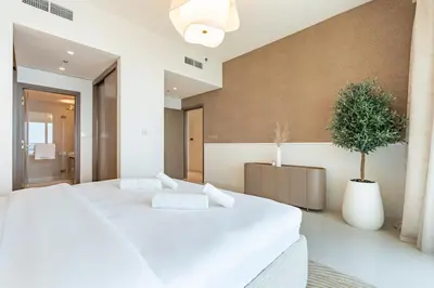 a bedroom with two white beds and a potted plant at Luxe 2 bedroom Apartment full Sea and Palm Views in Dubai