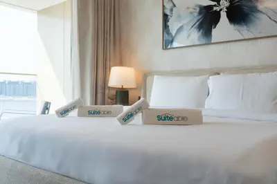 a bedroom with a white bed with two boxes on it at Luxe 2 bedroom Apartment full Sea and Palm Views in Dubai