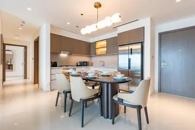 a kitchen and dining room with a table and chairs at Luxe 2 bedroom Apartment full Sea and Palm Views in Dubai
