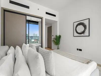 a living room with white furniture and a large window at Chic and Stylish 1 BDR in Binghatti corner - JVC in Dubai