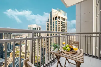 a bowl of fruit on a table on a balcony at Modern Creekside 1BR Near Dubai Mall & Downtown in Dubai