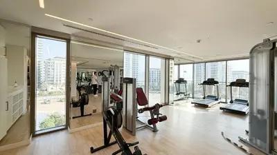 a gym with treadmills and exercise equipment in a building at Modern Creekside 1BR Near Dubai Mall & Downtown in Dubai