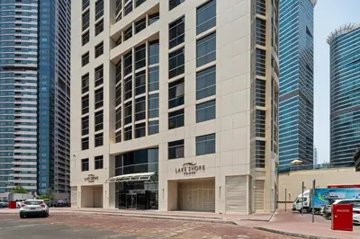 a building with a sign on the front of it at Luxury JLT Studio Renovated Lake View Metro in Dubai